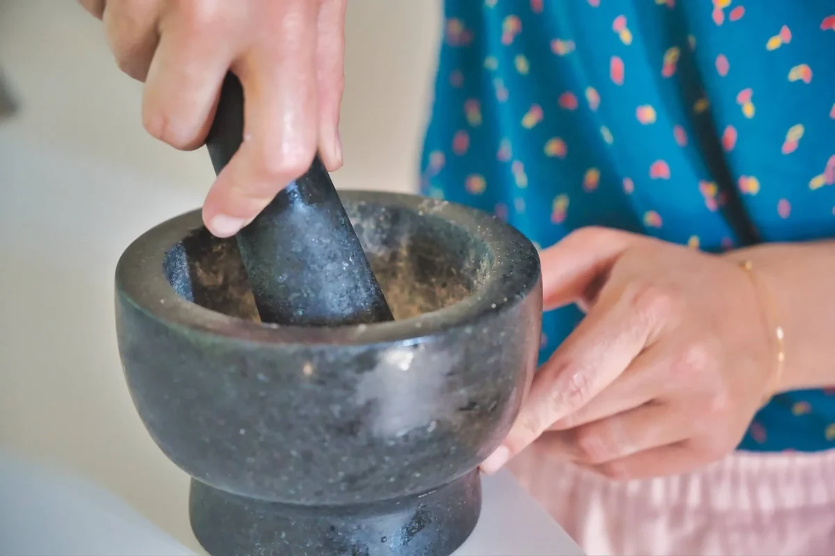 Traditional mortar and pestle used for grinding coffee beans