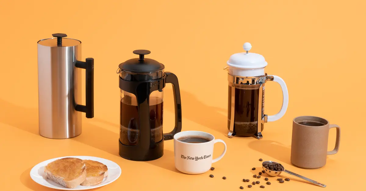Various French press coffee makers in black, white, and stainless steel on an orange background with coffee cups